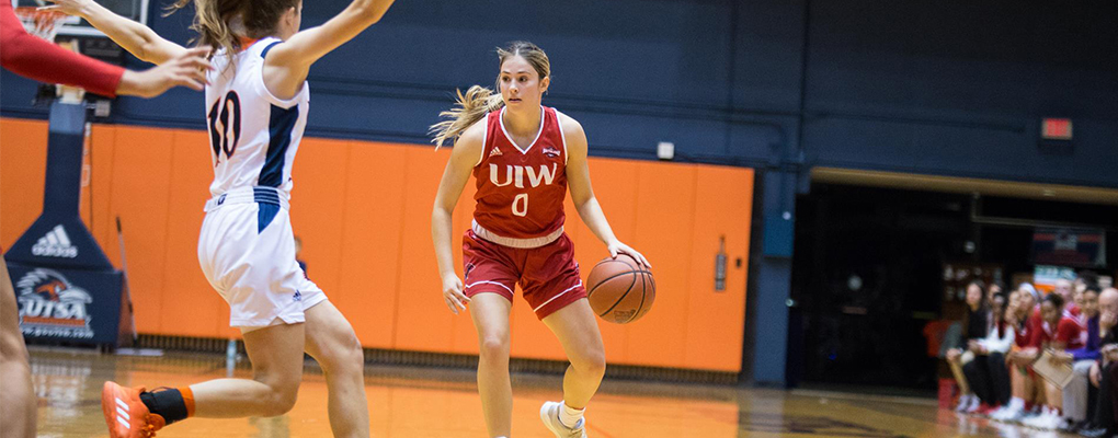 A UIW women's basketball player dribbles a ball down the court