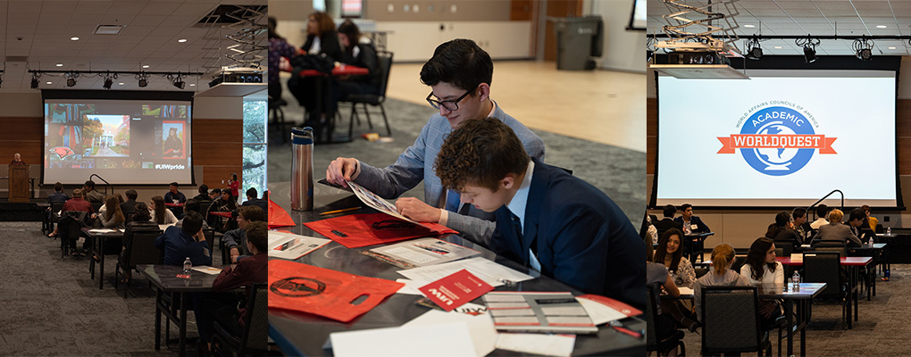 Two students look over materials at a table