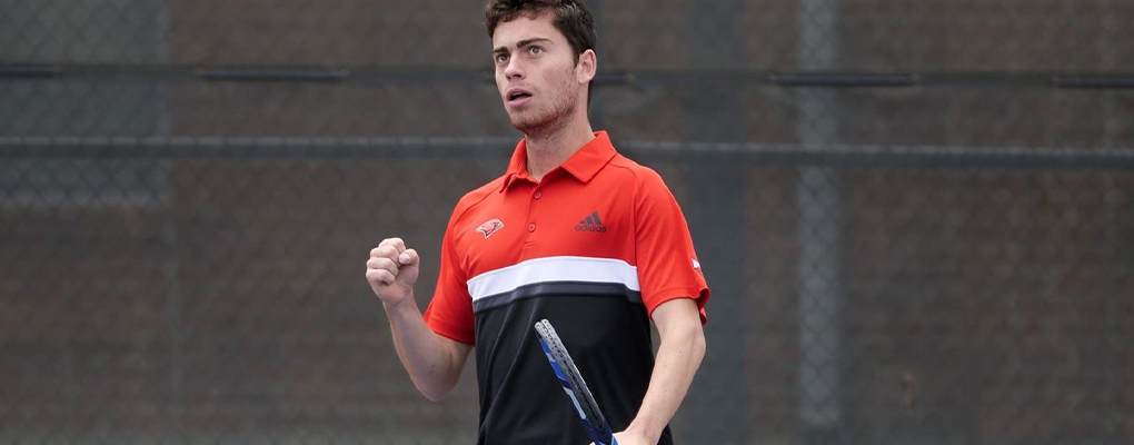 A tennis player pumps his fist in the air