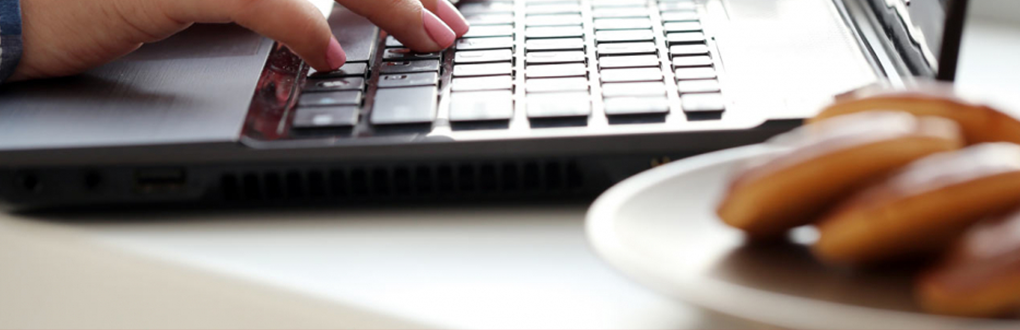 cookies on a plate next to a laptop