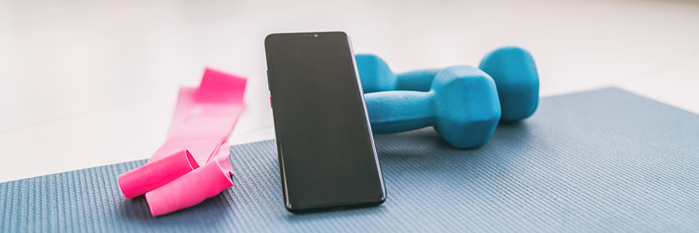 Workout Equipment and Phone on Mat